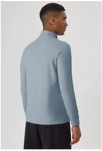 Back view of men's half-zip thermal long-sleeve sports top in light blue for cycling