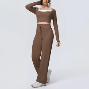 Elegant brown long-sleeved yoga set featuring wide-leg pants for fitness and pilates training.
