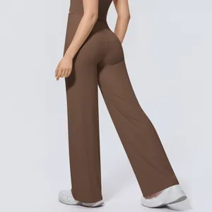 Back view of brown high-waisted wide-leg yoga pants showing relaxed fit and drape