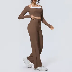 Full length side view of a woman wearing a brown long sleeve yoga set with flared pants