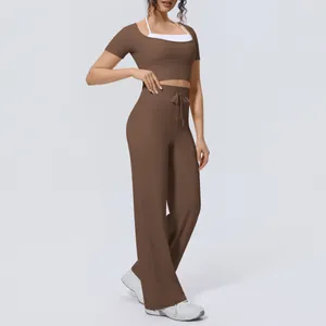 Detailed view of women's brown athletic yoga set with wide-leg pants and crop top