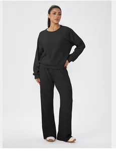 Women's black waffle knit tracksuit set with long sleeve top and wide-leg trousers