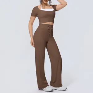 Full view of women's yoga set featuring coffee brown top and wide-leg pants silhouette