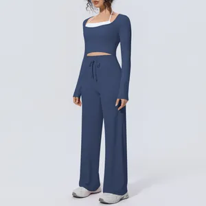 Women's two-piece yoga set featuring long sleeve crop top and high-waist wide leg pants