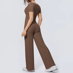 Back view of a brown two-piece yoga set featuring a short sleeve top and wide leg trousers