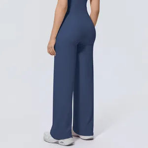 Back view detail of high-waisted wide-leg navy blue sports pants for women
