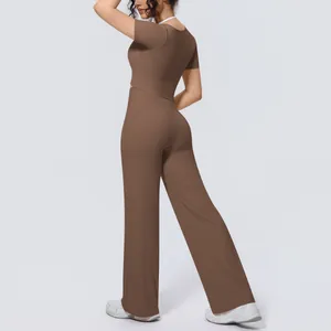 Back view of brown two-piece yoga set with short sleeve top and wide-leg pants