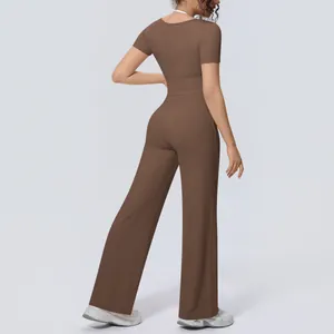 Back view of brown two-piece yoga set with short-sleeve top and wide-leg pants