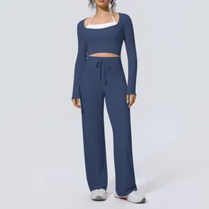Detail view of women's blue color-block yoga set with long sleeve top and wide-leg pants