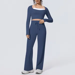 Detail view of navy blue two-piece yoga set with long sleeve top and wide leg pants
