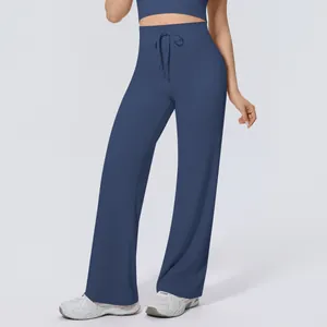 Close-up detail of high-waisted navy blue wide-leg yoga pants with drawstring waist