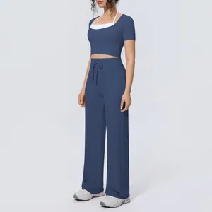 Side view detail of a blue two-piece yoga set featuring a crop top and wide-leg pants