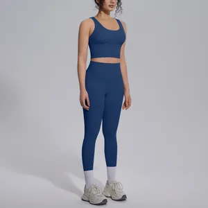 Full view of woman wearing deep blue V-neck sports bra and high-waist yoga leggings set