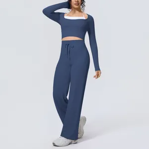 Two-piece blue yoga set featuring a long-sleeve crop top and wide-leg pants