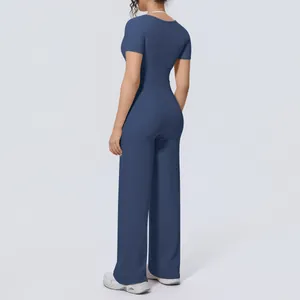 Back view of navy blue yoga set featuring short sleeve top and wide-leg trousers