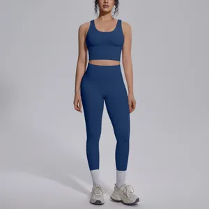 Woman in a premium dark blue V-neck sports bra and high-waisted yoga leggings set.