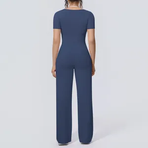 Back view of navy blue yoga set featuring short-sleeved top and wide-leg trousers.