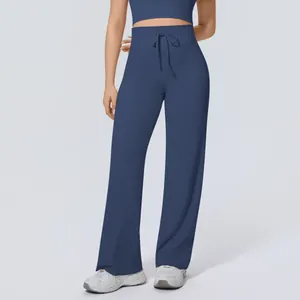 Detailed view of high-waisted drawstring wide-leg yoga pants in navy blue color