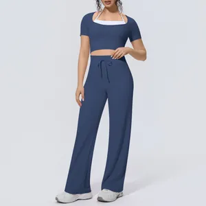 Full view detail of two-piece blue yoga set with halter crop top and wide leg pants