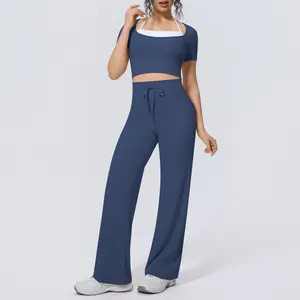 Detail view of women's blue yoga set with cropped short sleeve top and wide leg pants