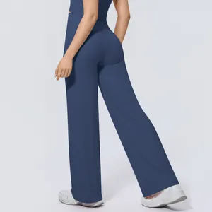 Back view of high-waisted wide-leg yoga pants in navy blue with premium soft drape fabric.