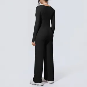 Back view detail of the slim fit black long sleeve athletic top and wide-leg pants