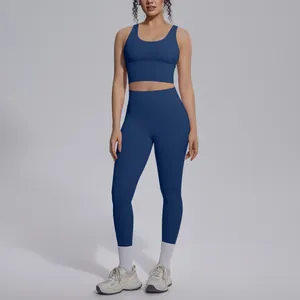Women's navy blue yoga set featuring high-waisted leggings and matching sports bra set
