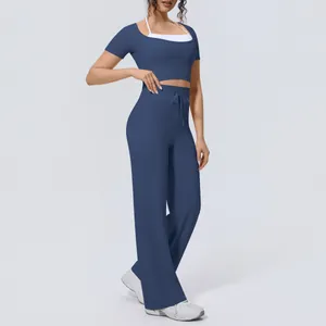 Muted blue two-piece athletic yoga set featuring wide-leg pants and a cropped top