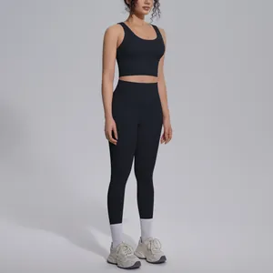 Two-piece black sport yoga set featuring a V-neck crop top and high-waisted leggings.
