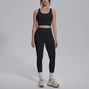 Professional model wearing a sleek black two-piece yoga fitness set for sports workout.