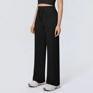 Close-up view of high-waisted black wide-leg sports pants with functional drawstring
