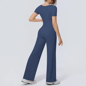 Back view of navy blue two-piece yoga set with short sleeve top and wide leg pants