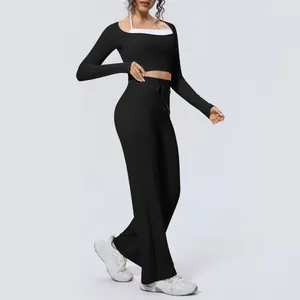 Detail view of black brushed yoga set with long sleeve crop top and wide leg pants