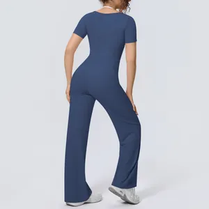 Back view of navy blue two-piece yoga set with short sleeve top and wide leg pants.