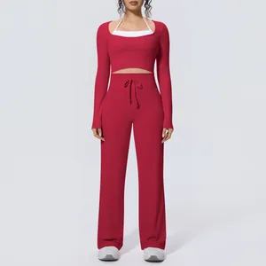 Red three-piece yoga set featuring long sleeve crop top and wide leg pants details