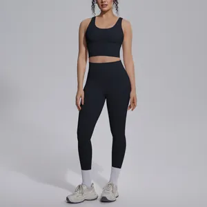 Full length view of black two-piece yoga set with V-neck sports bra and high-waisted leggings.