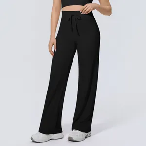 Detail view of black high-waisted wide-leg yoga pants with adjustable drawstring waist