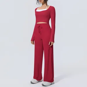 Stylish two-piece yoga set featuring a long sleeve crop top and matching wide leg pants
