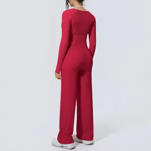 Back view of red brushed yoga set featuring long sleeve top and wide leg pants