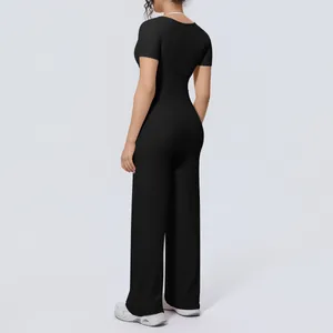 Back view of a black yoga set with short sleeve top and wide leg pants for women