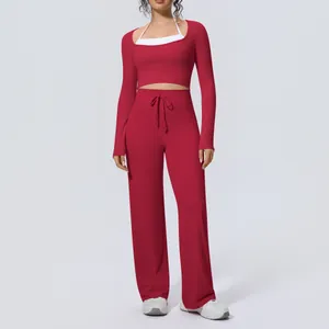 Full view of women's burgundy long-sleeve yoga set with white contrast and wide-leg pants