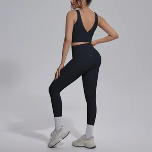 Detail view of black yoga set featuring V-neck sports bra and high-waisted leggings
