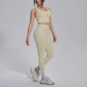 Full body view of a woman wearing a pale yellow V-neck sports bra and matching yoga leggings