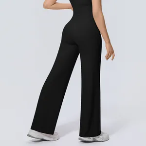 Back view of high waisted wide leg yoga pants in black showing elegant drape and fit