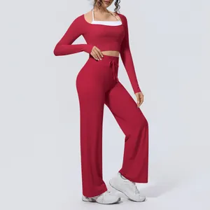 Stylish red fitness yoga set featuring a long sleeve crop top and matching wide-leg pants