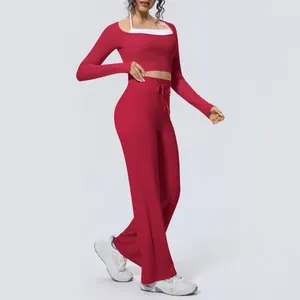 Women's red yoga set with long sleeve crop top and wide-leg flare pants for fitness