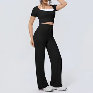 Women's two-piece yoga outfit with short sleeve crop top and high waist wide leg pants