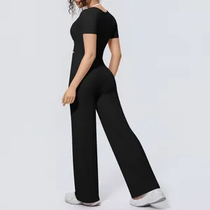 Back view of black two-piece yoga set featuring wide-leg pants and stylish crop top