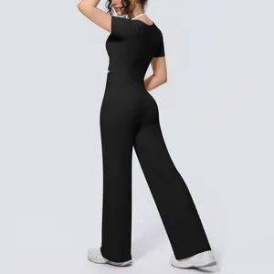 Back view of women's black yoga set with short sleeve top and wide-leg trousers