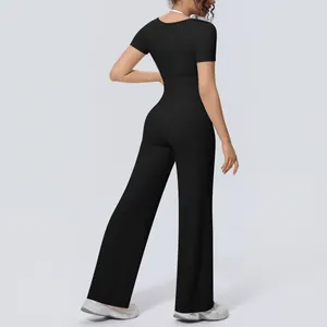 Back view of a women's black yoga set with wide-leg pants and athletic short sleeve top
